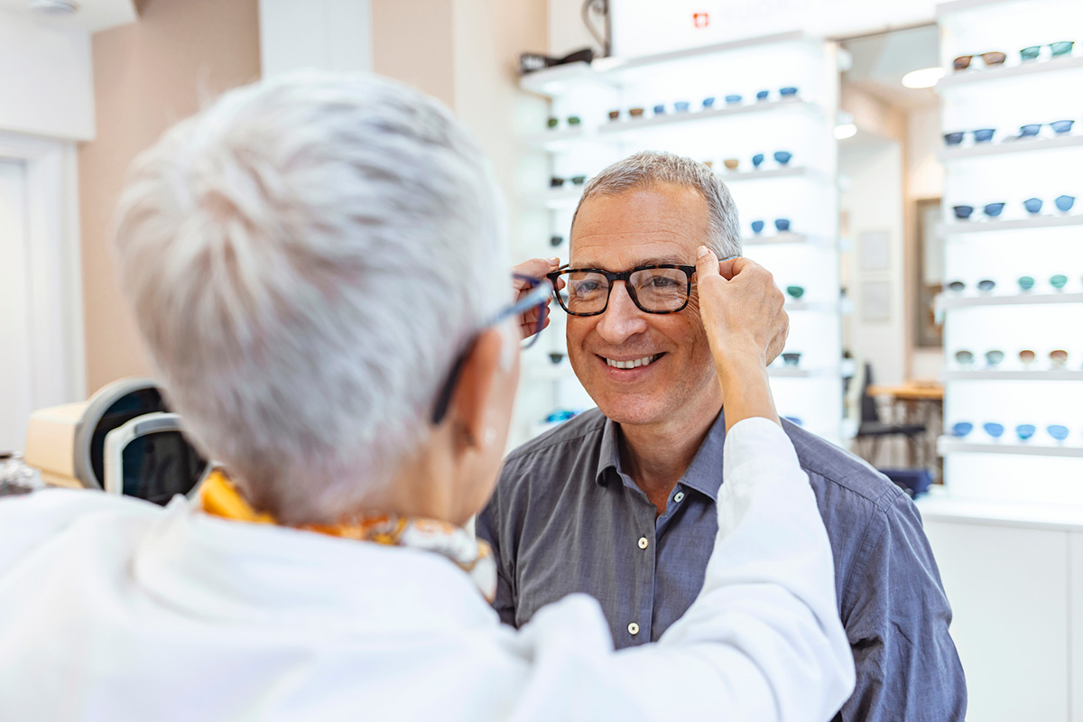 Older couple trying on stylish eyeglass frames