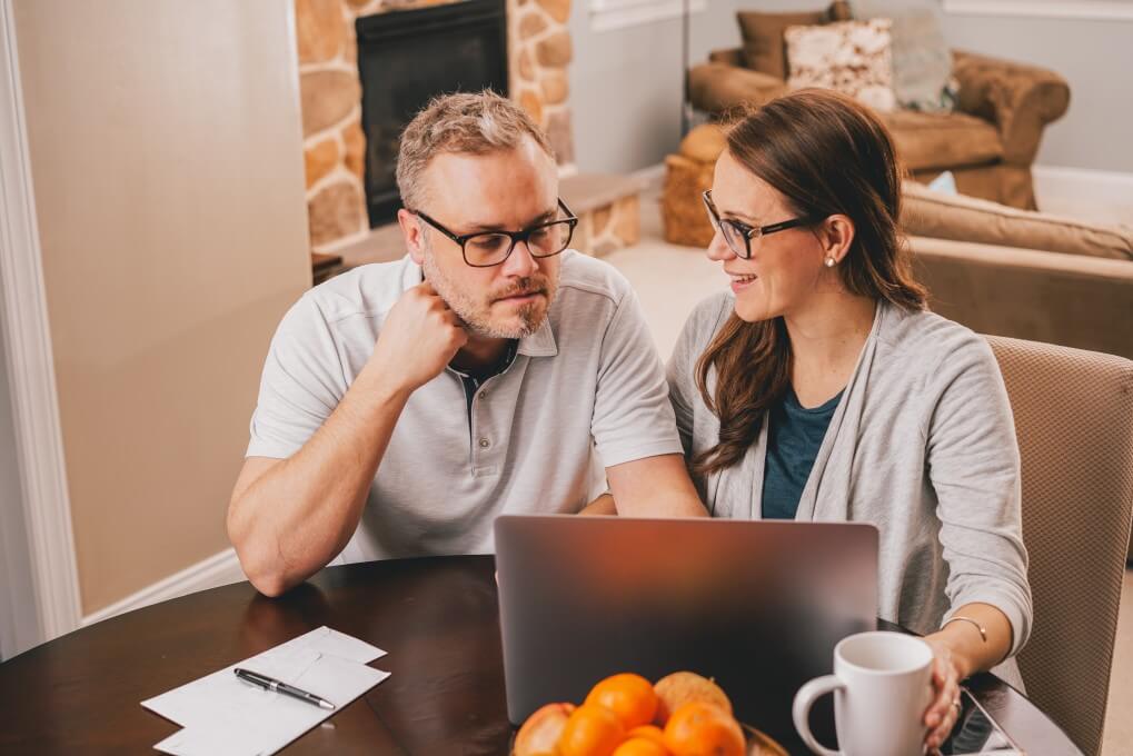 Middle aged couple working on a  laptop together.